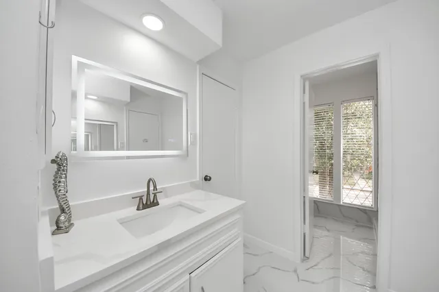 a bathroom with a sink and a mirror