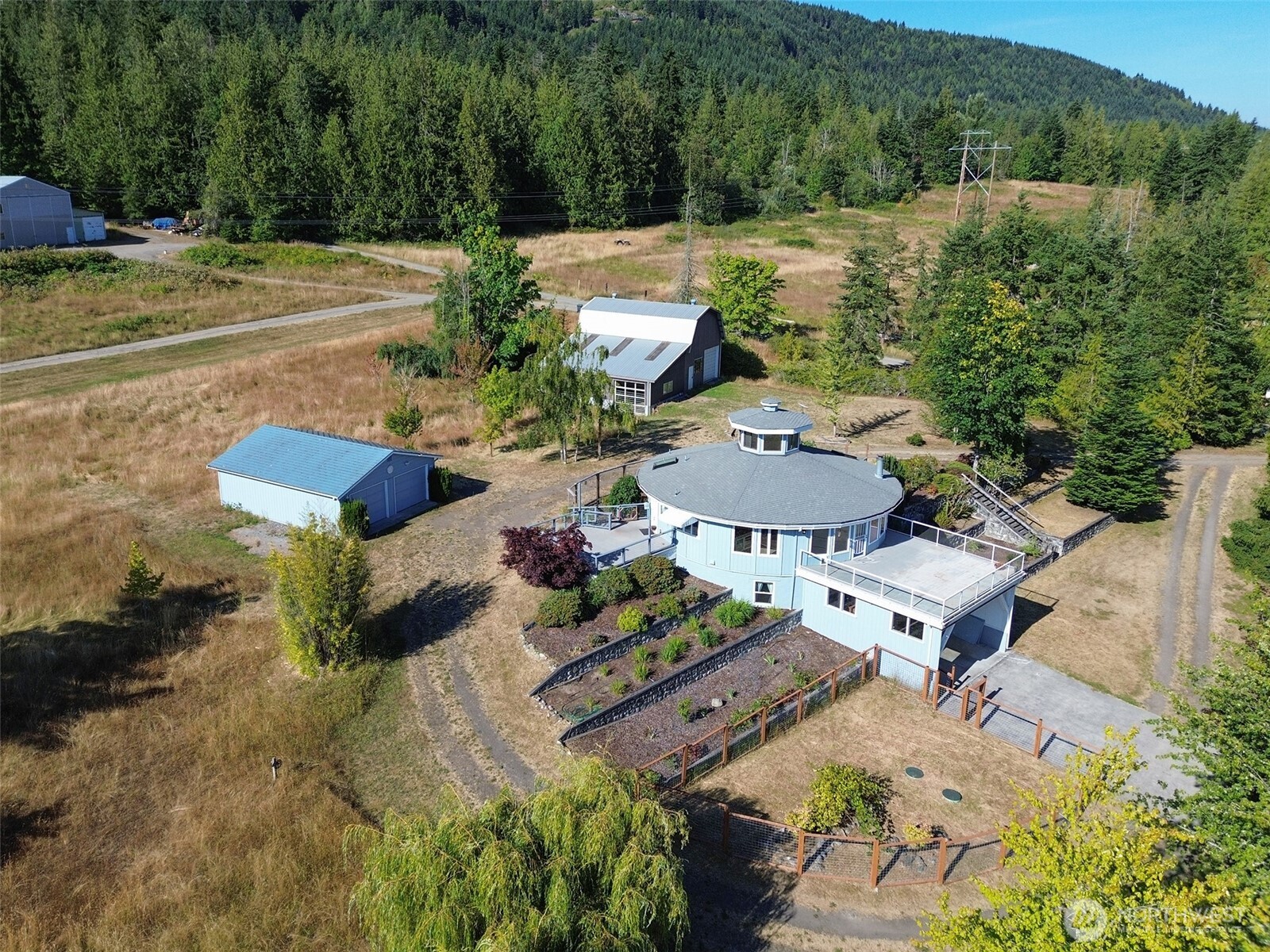 63 Hummingbird Lane Sequim, WA 98382 - Photo 1 of 40 an aerial view of a house with yard and seating space