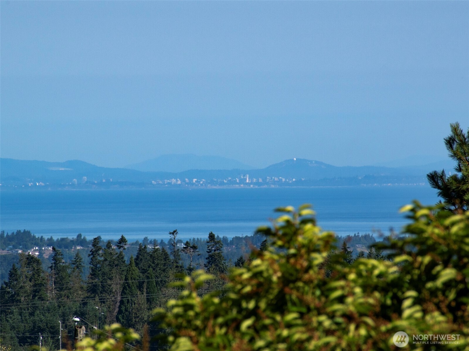 63 Hummingbird Lane Sequim, WA 98382 - Photo 11 of 40 a view of a lake with a city