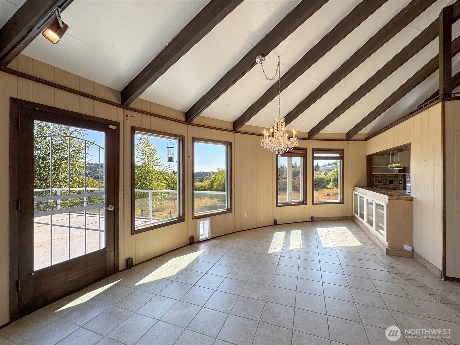 63 Hummingbird Lane Sequim, WA 98382 - Photo 13 of 40 a view of an empty room with a fireplace and a large window