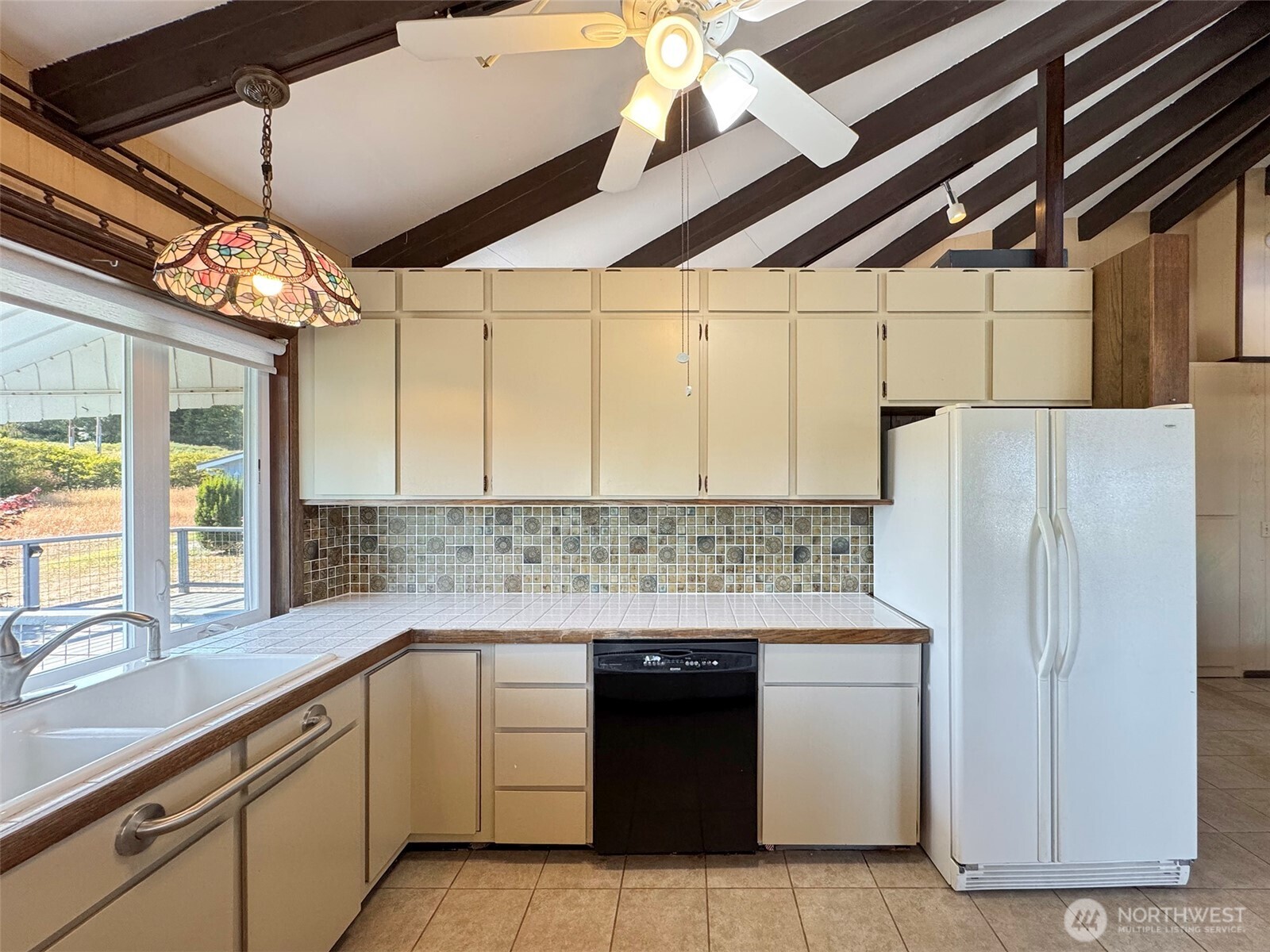63 Hummingbird Lane Sequim, WA 98382 - Photo 16 of 40 a kitchen with stainless steel appliances granite countertop a sink and a refrigerator