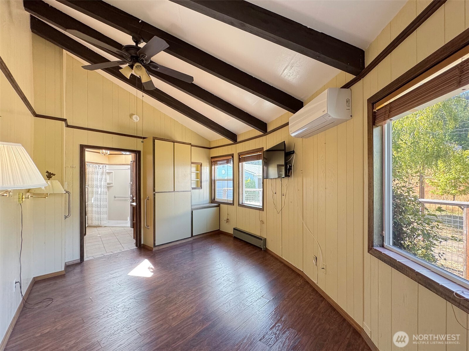 63 Hummingbird Lane Sequim, WA 98382 - Photo 24 of 40 a view of an empty room with wooden floor and windows