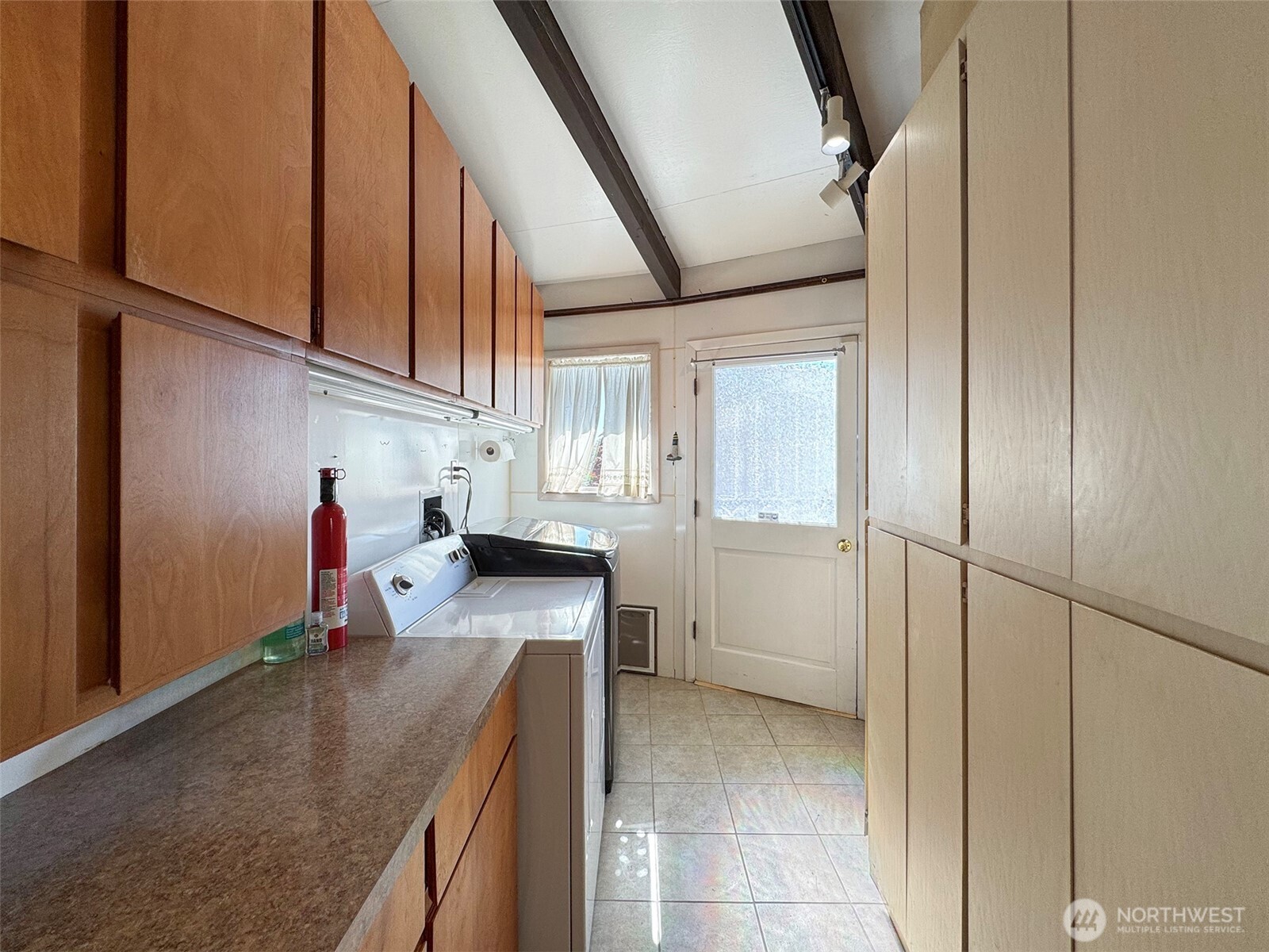63 Hummingbird Lane Sequim, WA 98382 - Photo 25 of 40 a kitchen view with stainless steel appliances granite countertop a sink refrigerator and cabinets