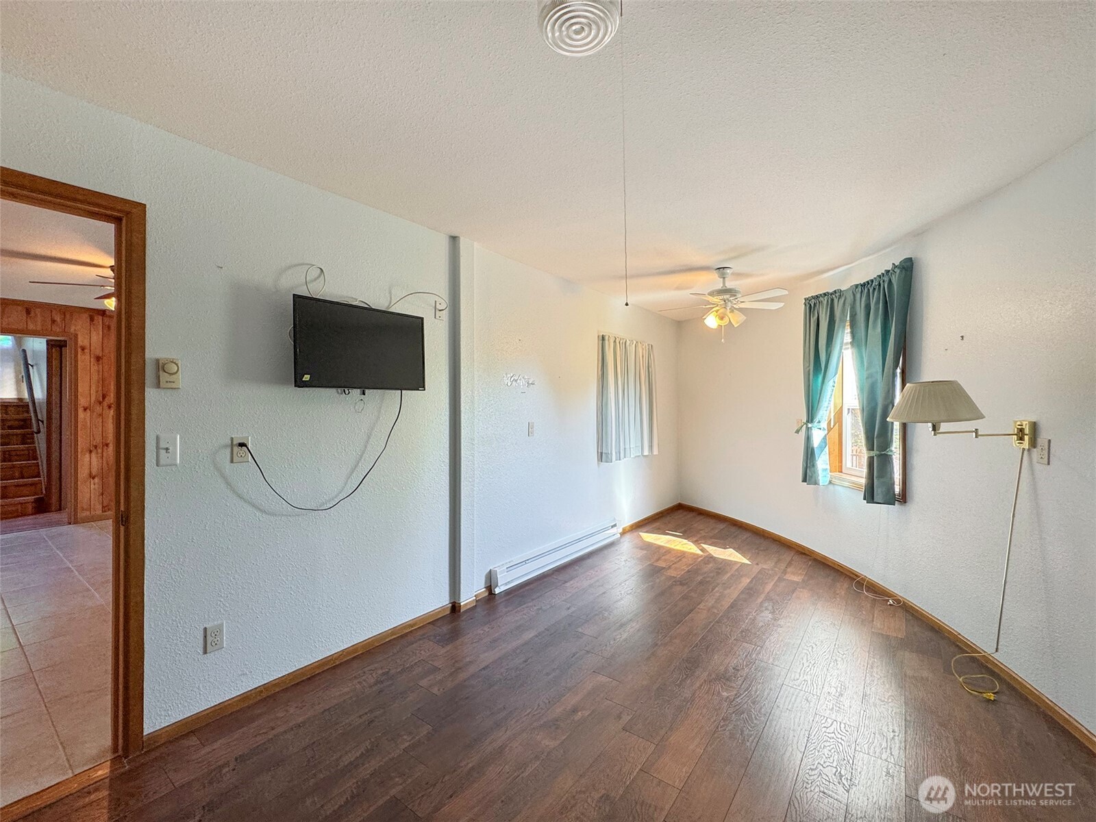 63 Hummingbird Lane Sequim, WA 98382 - Photo 30 of 40 a view of a livingroom with wooden floor and a ceiling fan