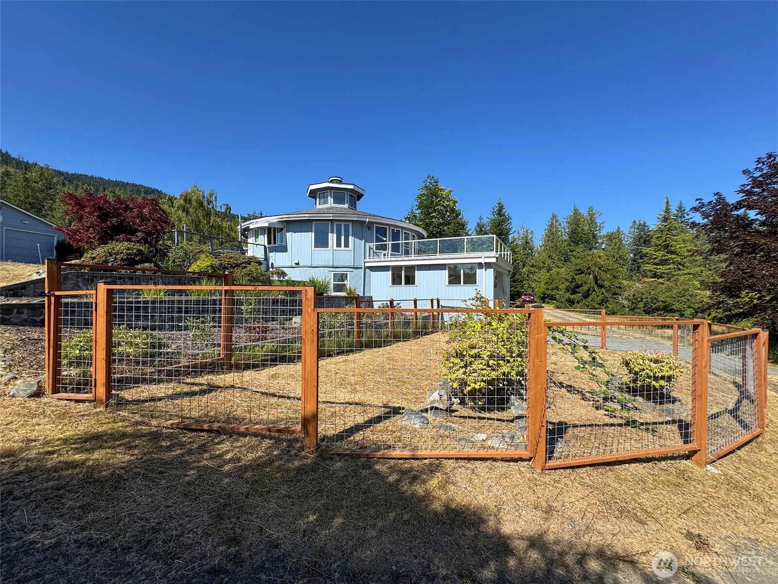 63 Hummingbird Lane Sequim, WA 98382 - Photo 36 of 40 a view of a house with wooden fence