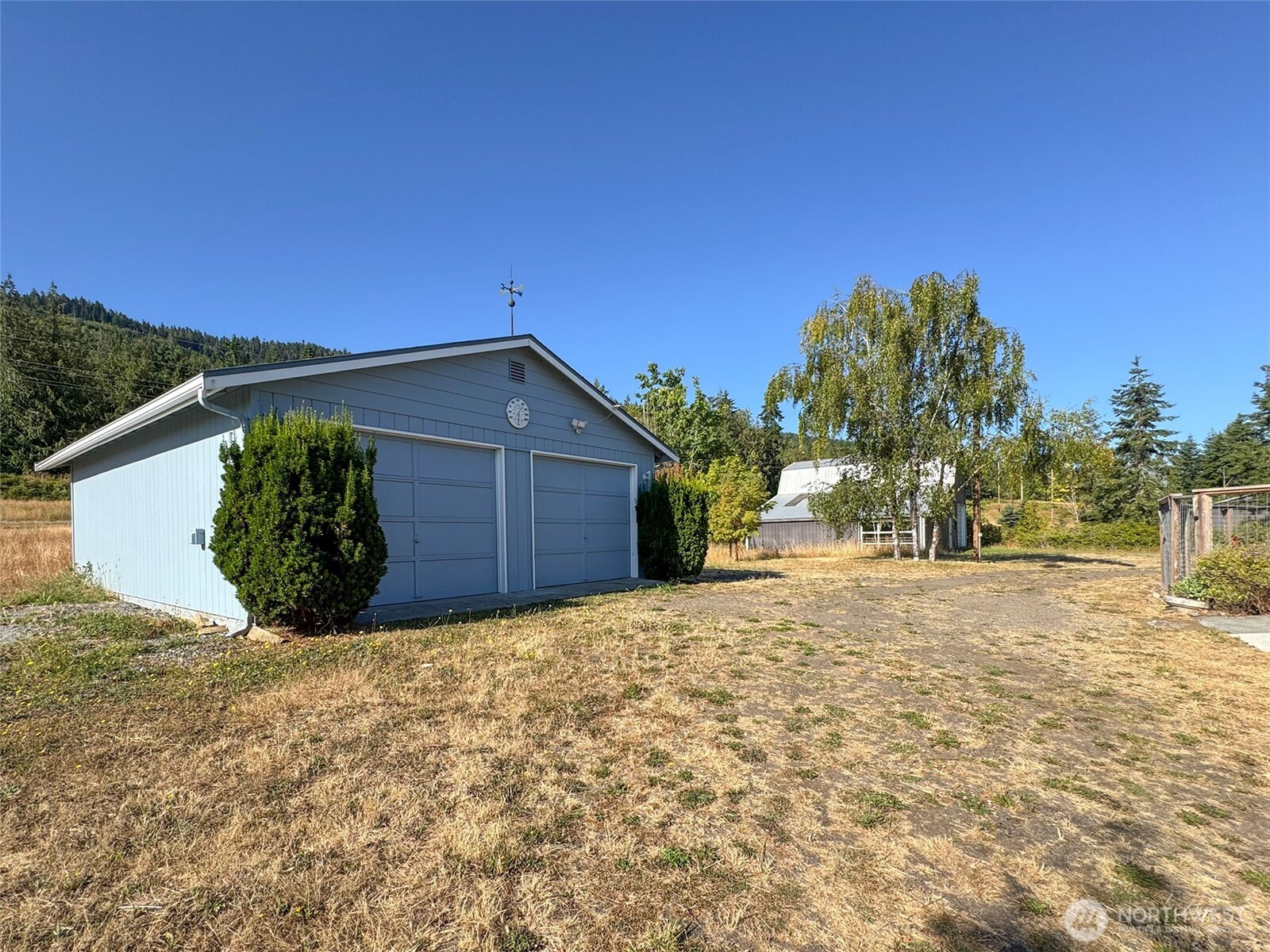 63 Hummingbird Lane Sequim, WA 98382 - Photo 38 of 40 a view of a house with a yard