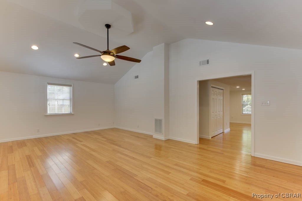 8729 Marlfield Road Gloucester, VA 23061 - Photo 13 of 32 Unfurnished room with light hardwood / wood-style floors, high vaulted ceiling, and ceiling fan