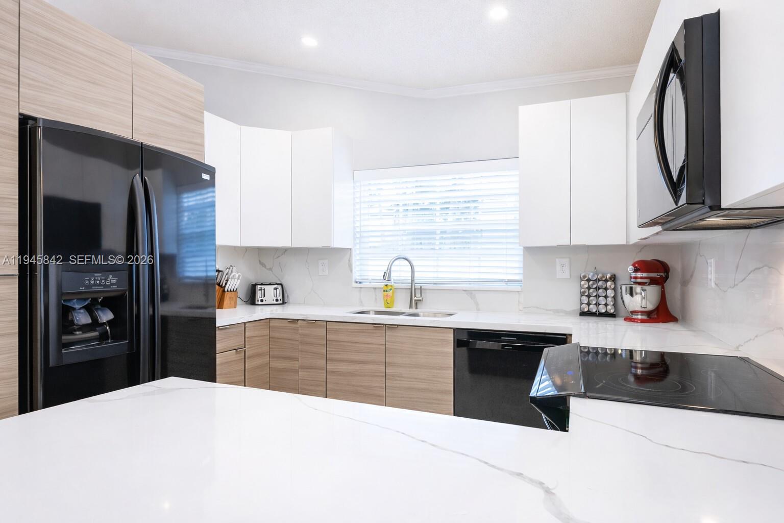11291 Southwest 62nd Terrace Miami, FL 33173 - Photo 11 of 23 a kitchen with stainless steel appliances kitchen island granite countertop a sink a stove and a refrigerator