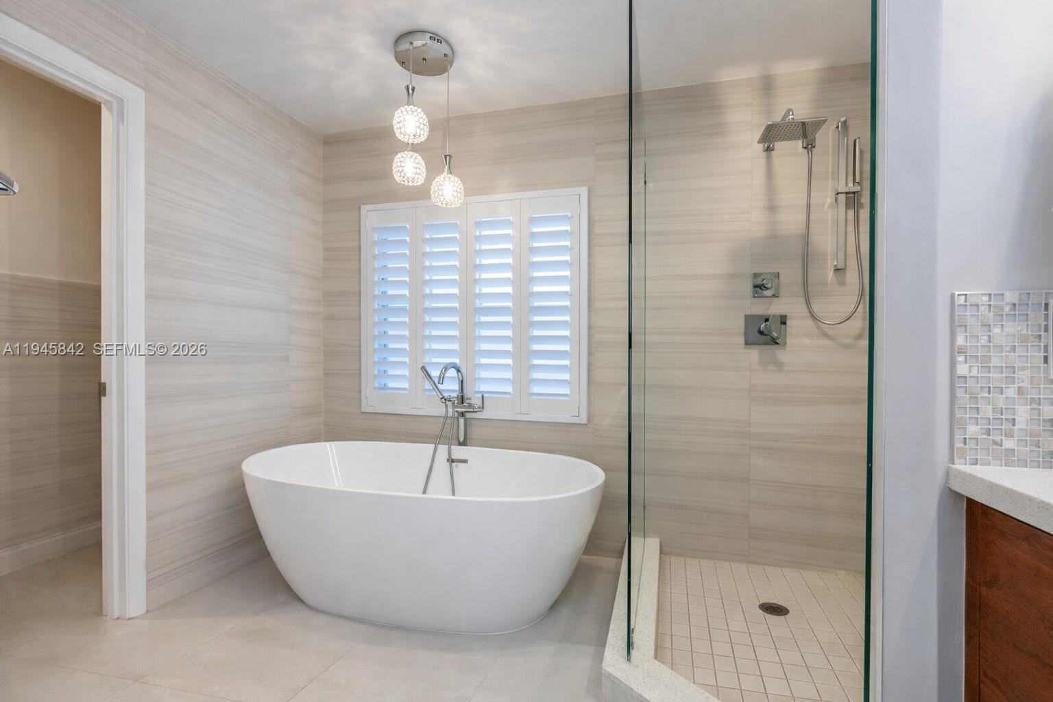 11291 Southwest 62nd Terrace Miami, FL 33173 - Photo 16 of 23 a white bath tub sitting next to a shower