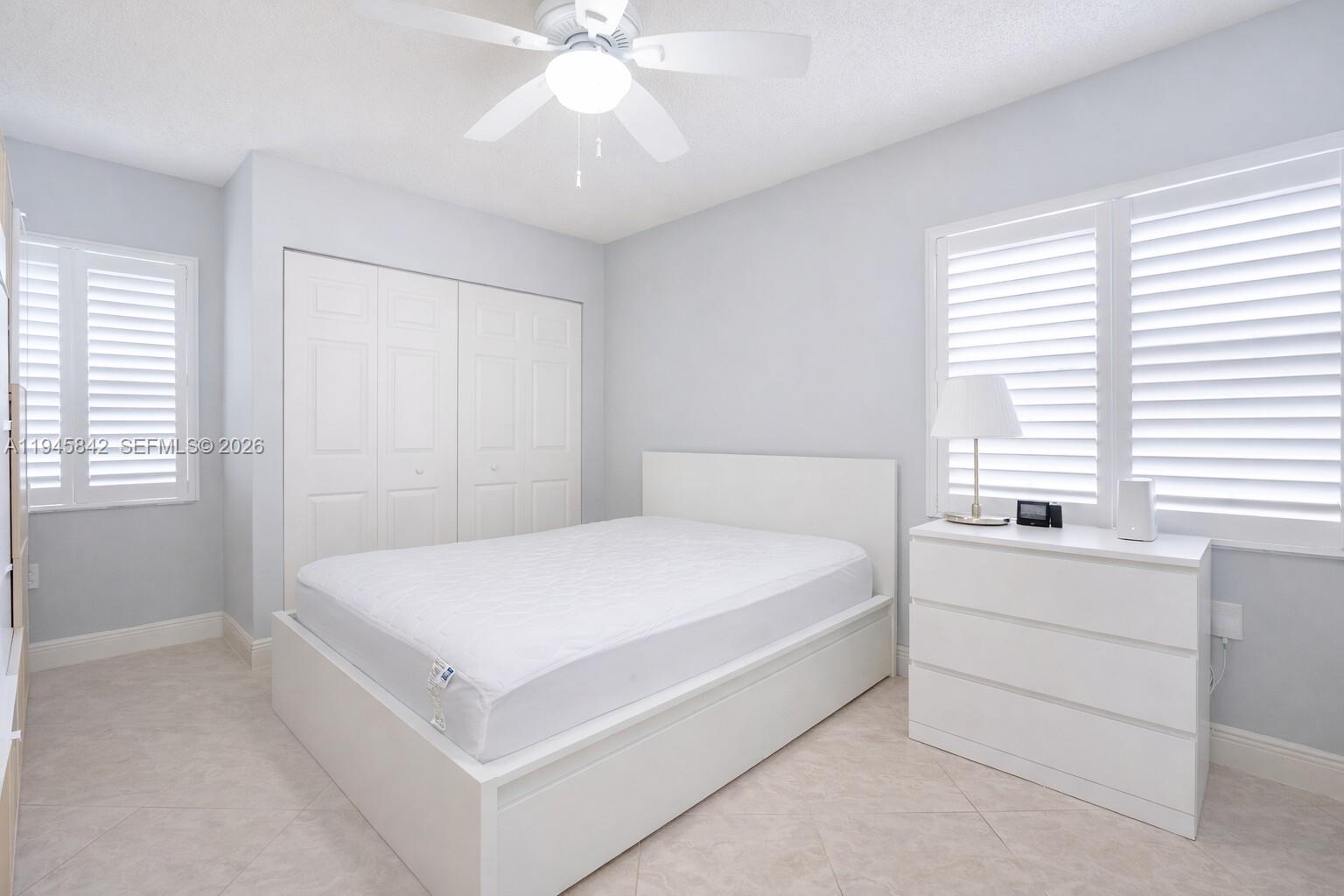 11291 Southwest 62nd Terrace Miami, FL 33173 - Photo 17 of 23 a spacious bedroom with a bed and a chandelier