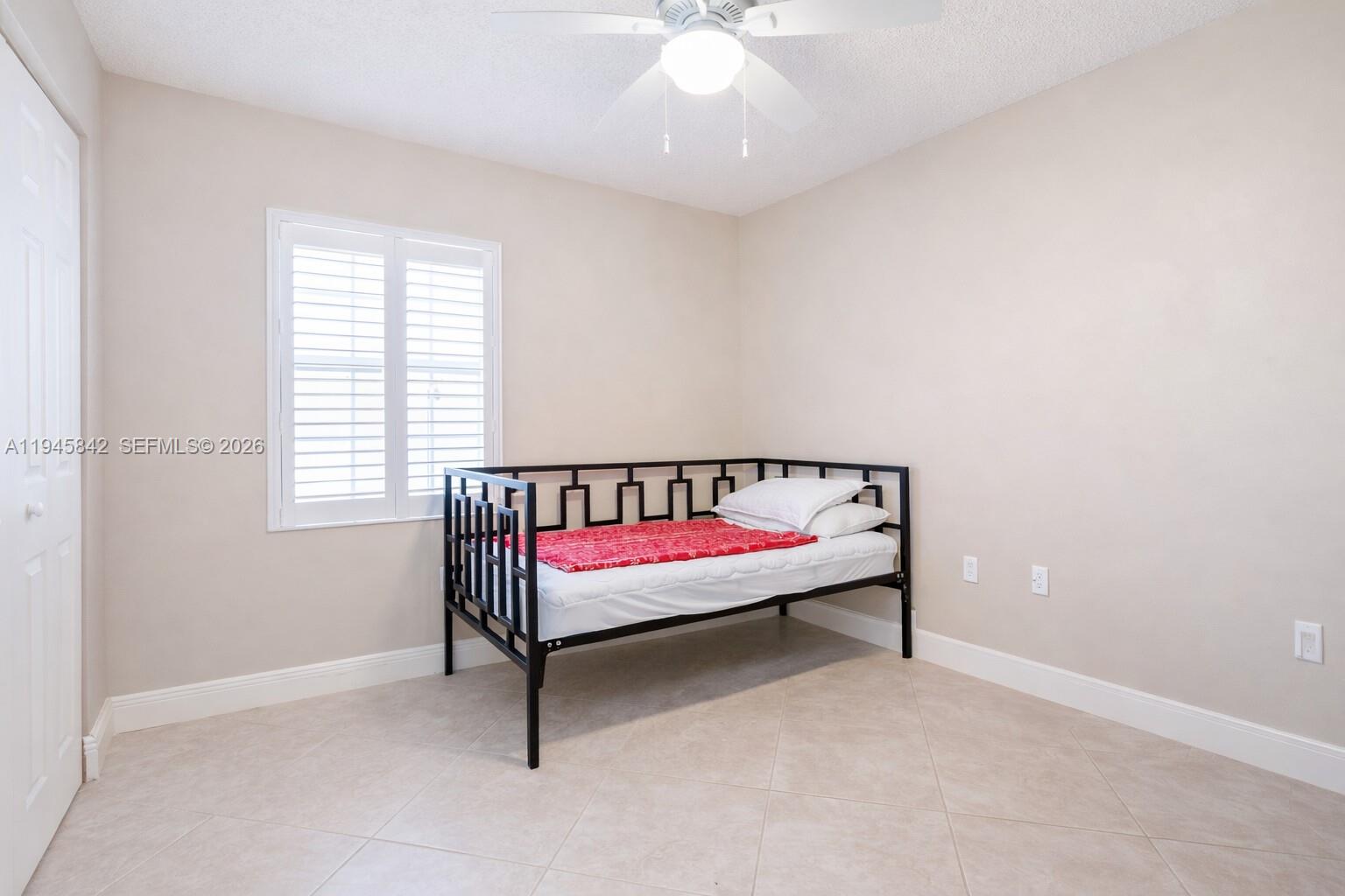 11291 Southwest 62nd Terrace Miami, FL 33173 - Photo 19 of 23 a bed room with a bed and a chandelier