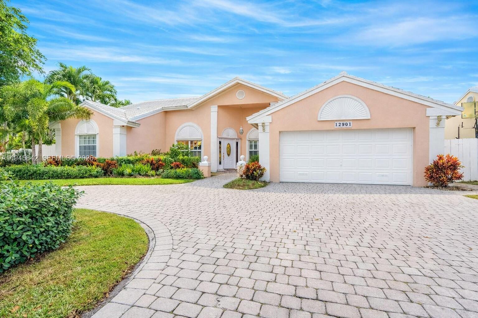 11291 Southwest 62nd Terrace Miami, FL 33173 - Photo 2 of 23 a view of a house with a yard and potted plants