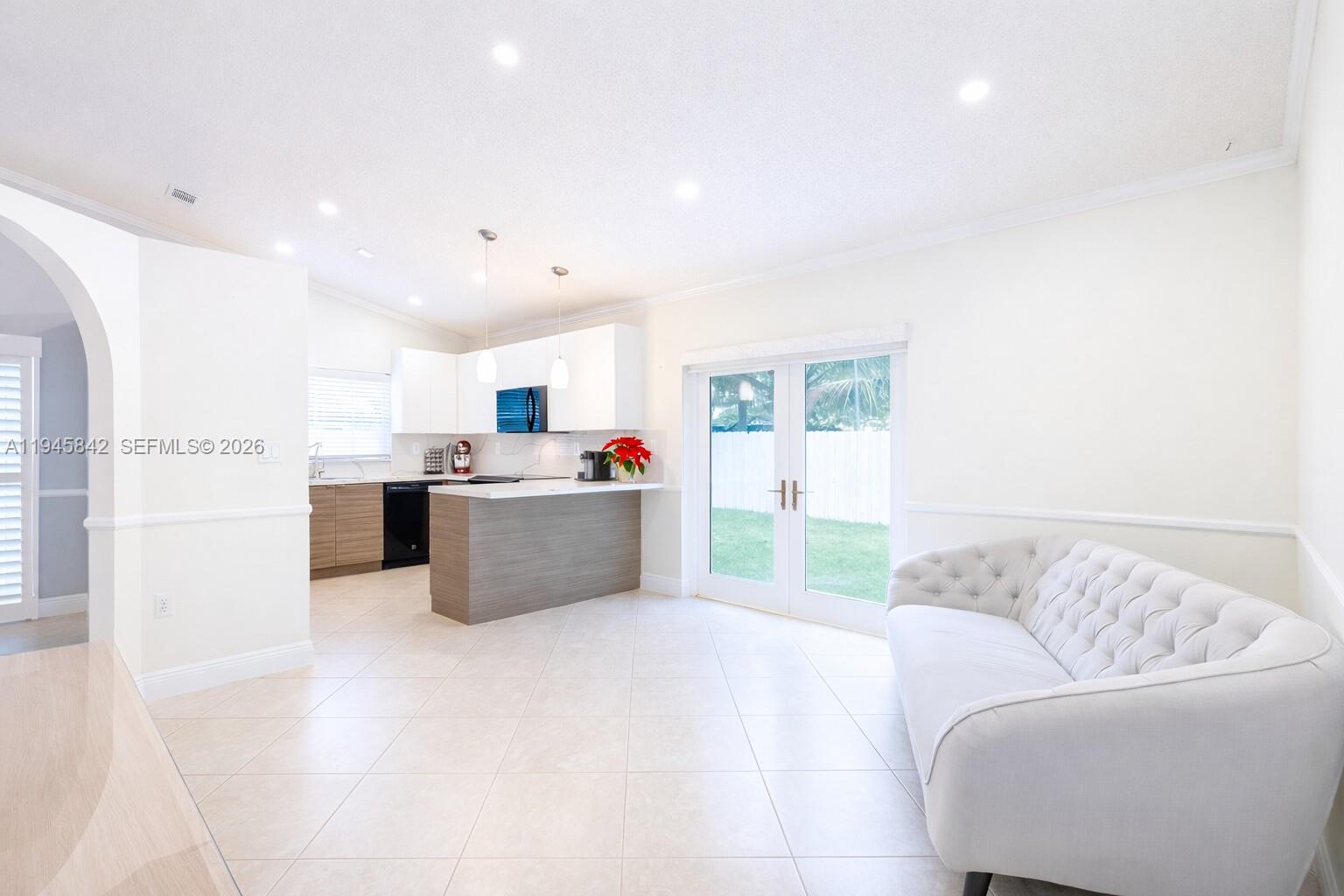 11291 Southwest 62nd Terrace Miami, FL 33173 - Photo 9 of 23 a living room with furniture and kitchen view