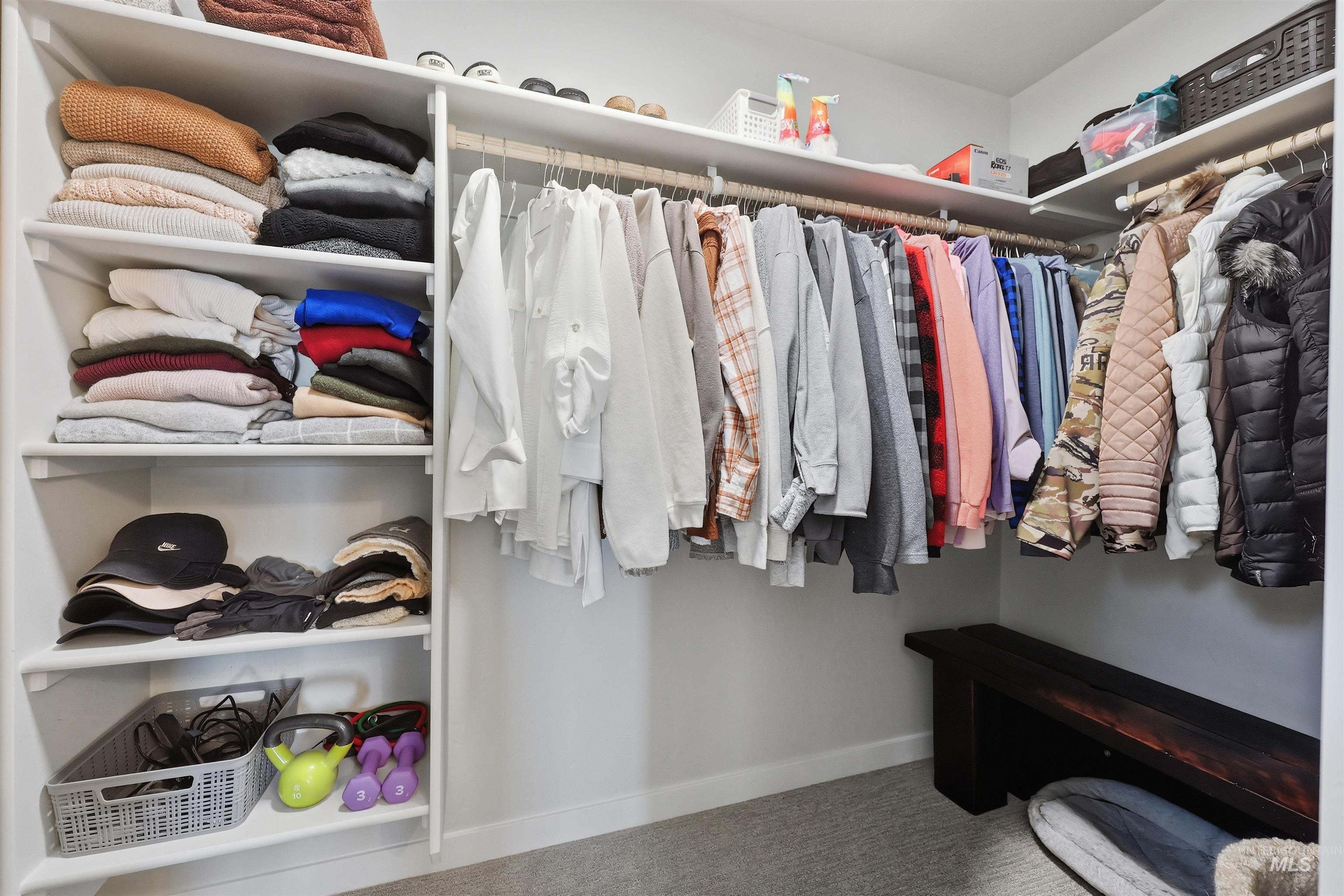 3811 West Maypearl Street Meridian, ID 83642 - Photo 26 of 39 Expansive walk-in closet featuring extensive built-in shelving, multiple hanging rods, and light gray carpet flooring