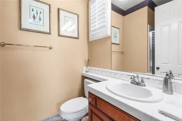 a bathroom with a sink vanity mirror and toilet