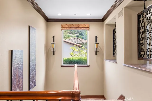 a view of a hallway with wooden floor and a large window