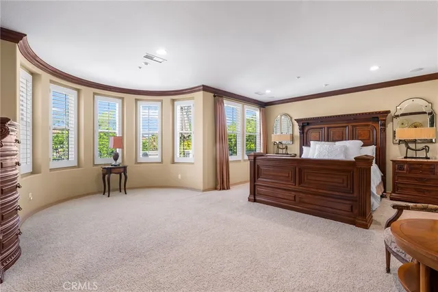 a bedroom with furniture and large windows