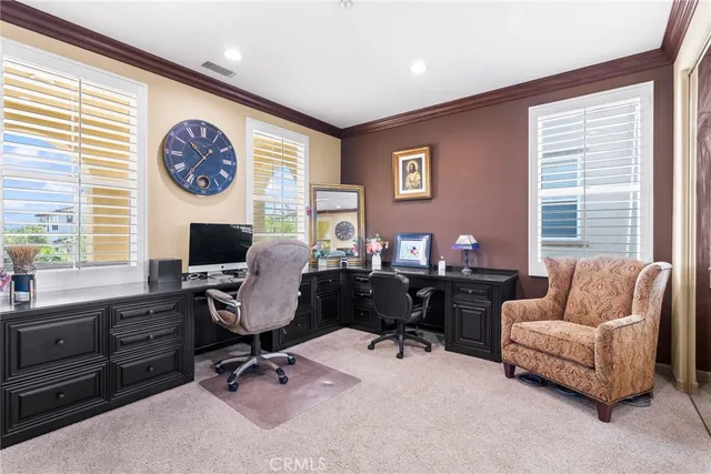 a view of a livingroom with workspace and a window