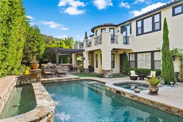 a front view of a house with swimming pool having outdoor seating