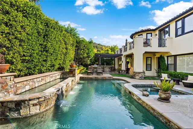a view of a house with swimming pool and sitting area