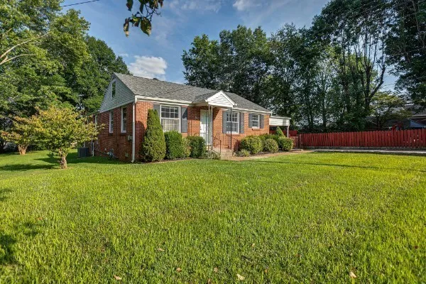 a front view of house with yard and green space