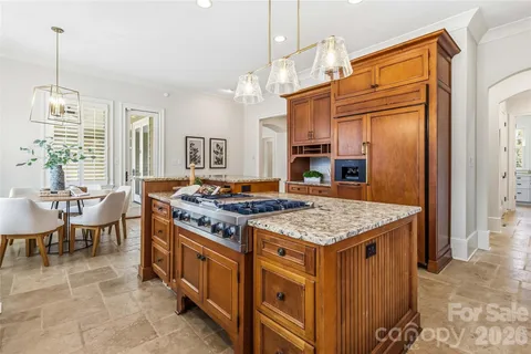 a kitchen with stainless steel appliances granite countertop a stove and a refrigerator