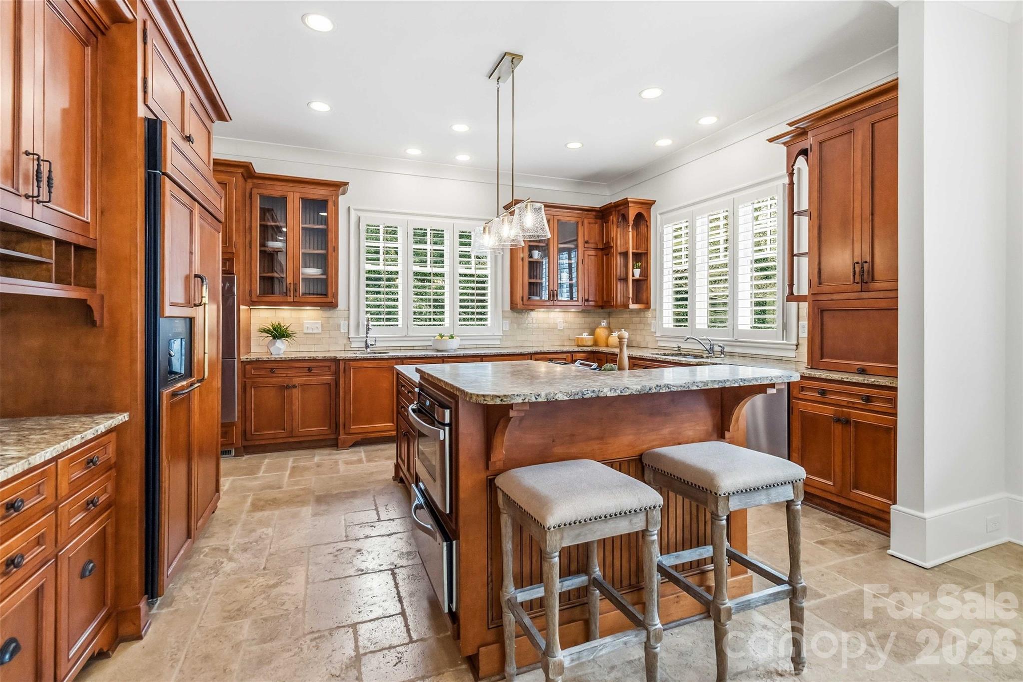 6321 Sharon Hills Road Charlotte, NC 28210 - Photo 16 of 46 a kitchen with granite countertop wooden cabinets and dining table