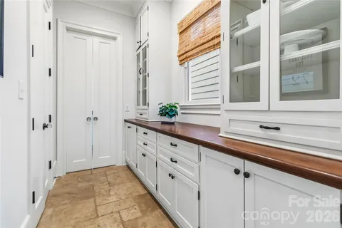 a kitchen with granite countertop white cabinets and white appliances