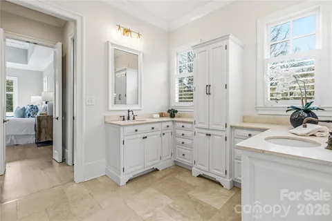 a spacious bathroom with double sink and a mirror