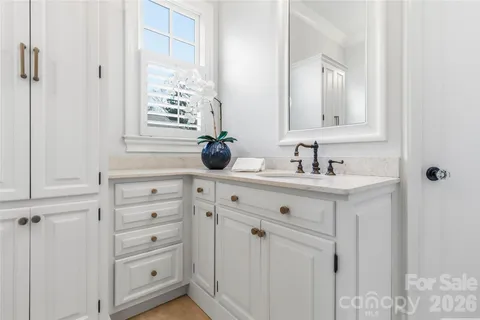 a bathroom with a sink vanity and mirror