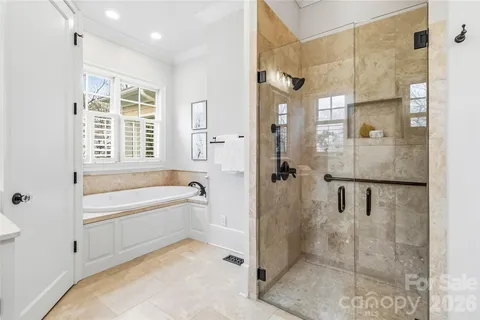 a spacious bathroom with a bathtub shower and a sink