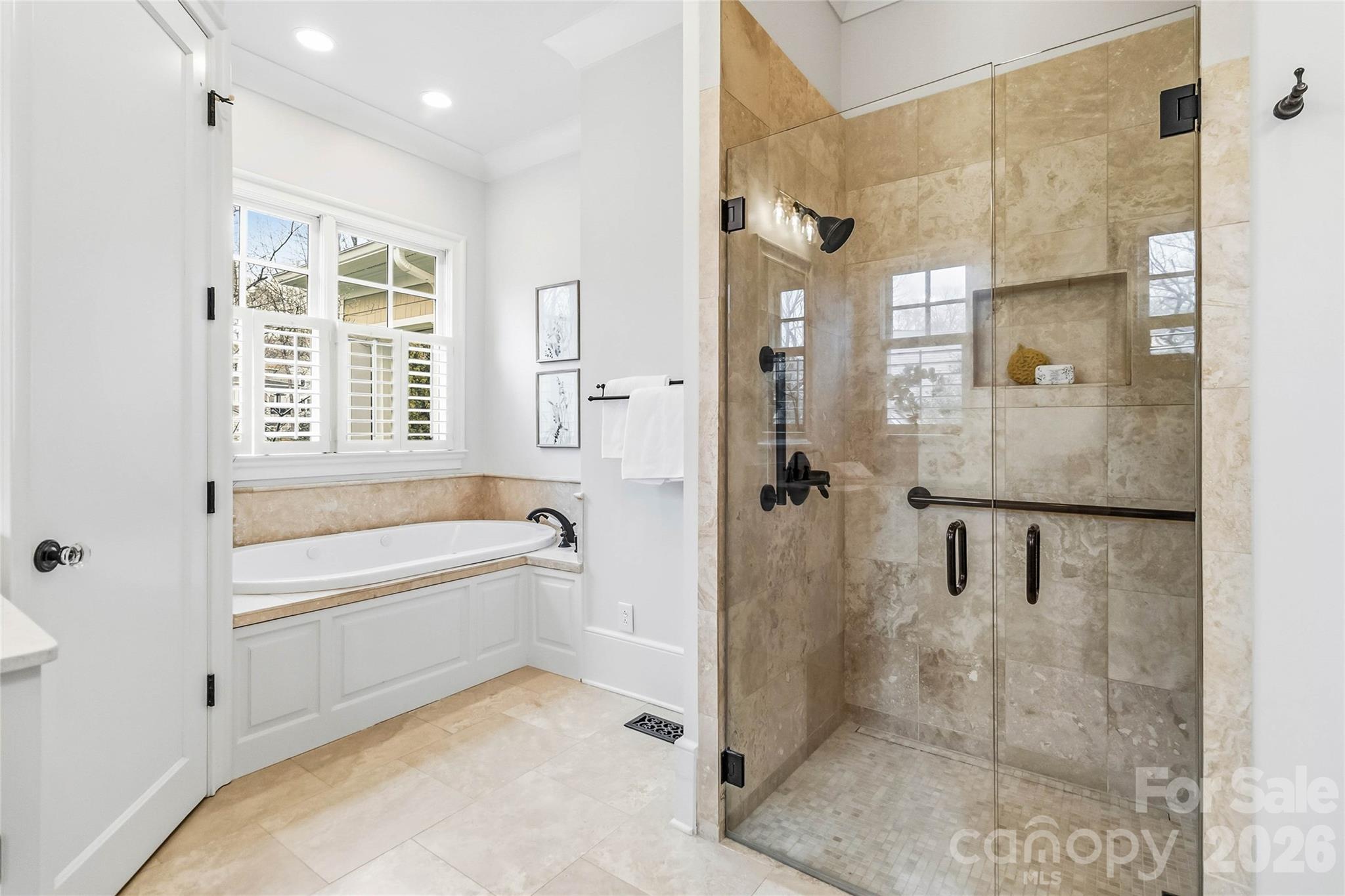6321 Sharon Hills Road Charlotte, NC 28210 - Photo 29 of 46 a spacious bathroom with a bathtub shower and a sink