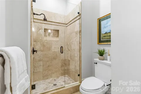 a white toilet sitting next to a bathroom sink