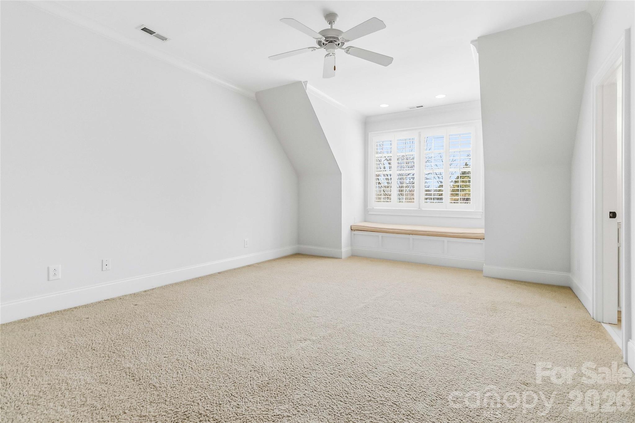 6321 Sharon Hills Road Charlotte, NC 28210 - Photo 40 of 46 an empty room with windows and ceiling fan