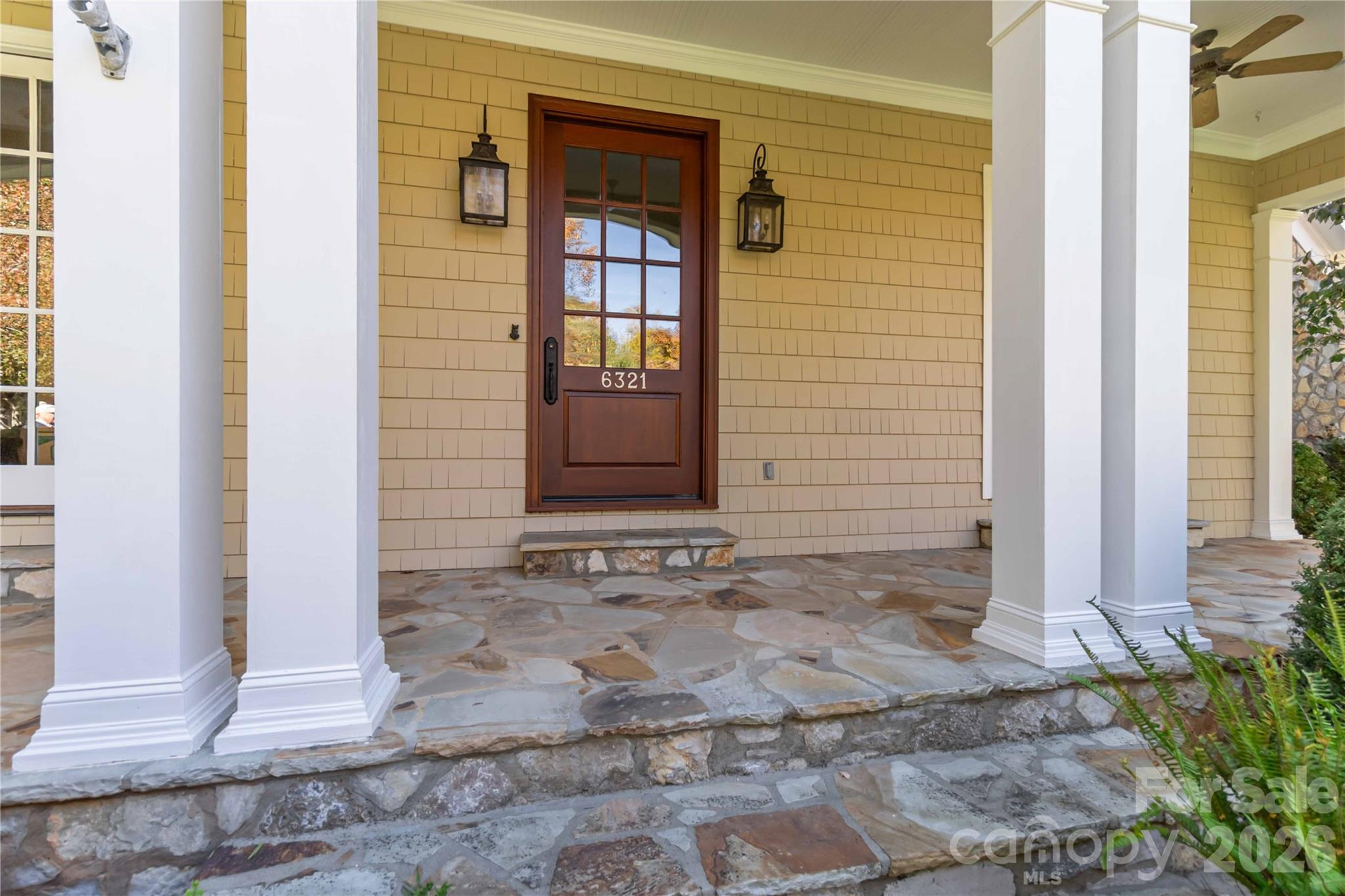 6321 Sharon Hills Road Charlotte, NC 28210 - Photo 5 of 46 a view of a brick house with potted plants