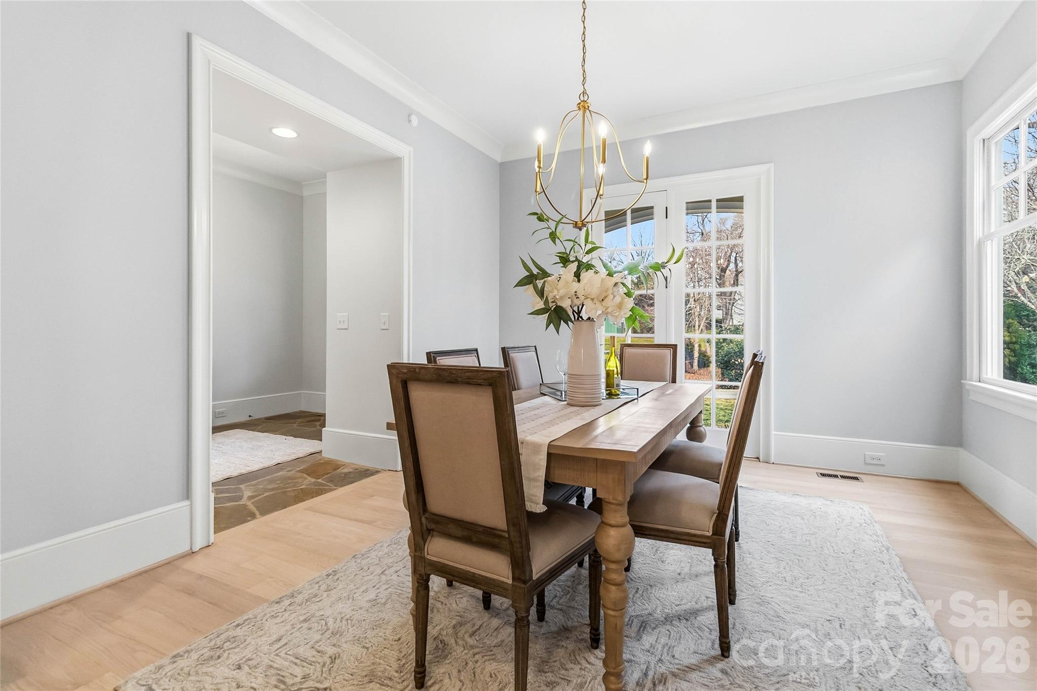 6321 Sharon Hills Road Charlotte, NC 28210 - Photo 7 of 46 a view of a dining room with furniture and a chandelier