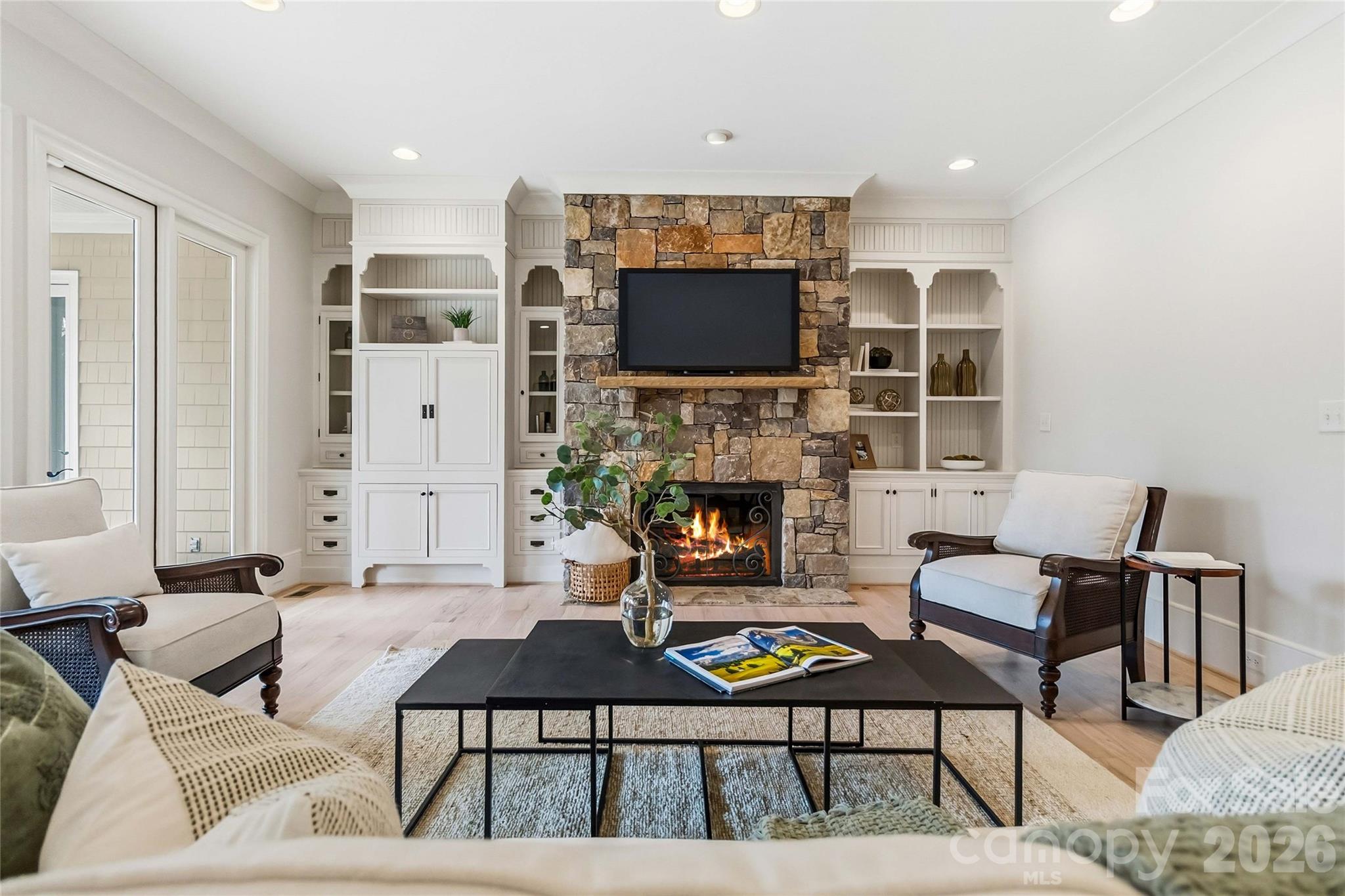 6321 Sharon Hills Road Charlotte, NC 28210 - Photo 10 of 46 a living room with furniture a flat screen tv and a fireplace