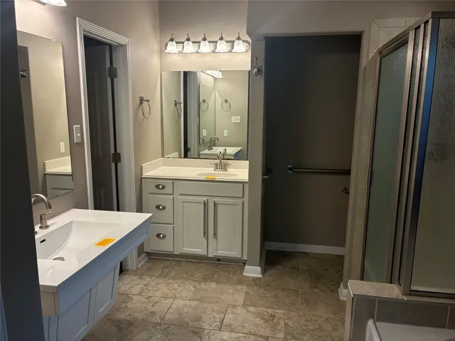 a bathroom with a tub sink and mirror
