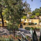 a view of a patio with table and chairs and potted plants