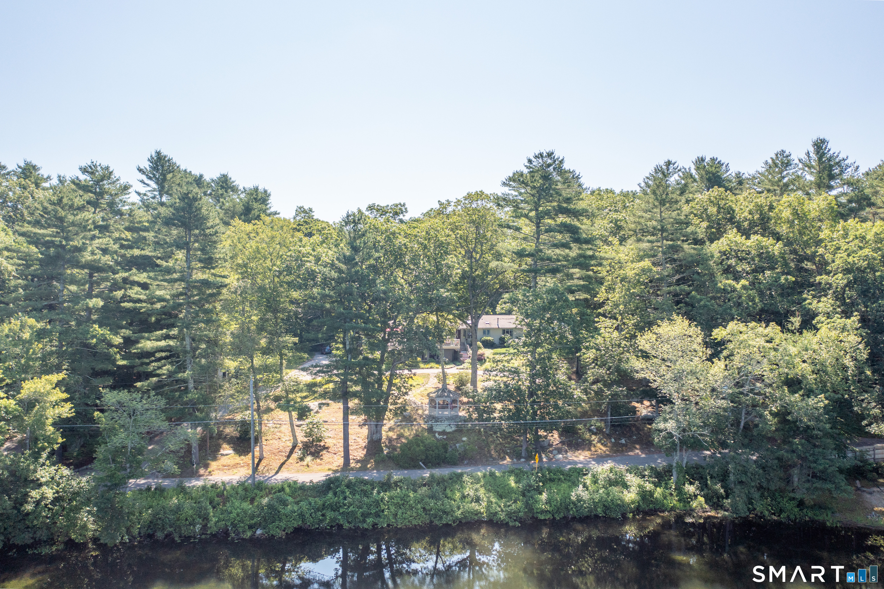 82 Kennerson Reservoir Road Ashford, CT 06278 - Photo 2 of 12 a backyard of a house with a yard and outdoor seating