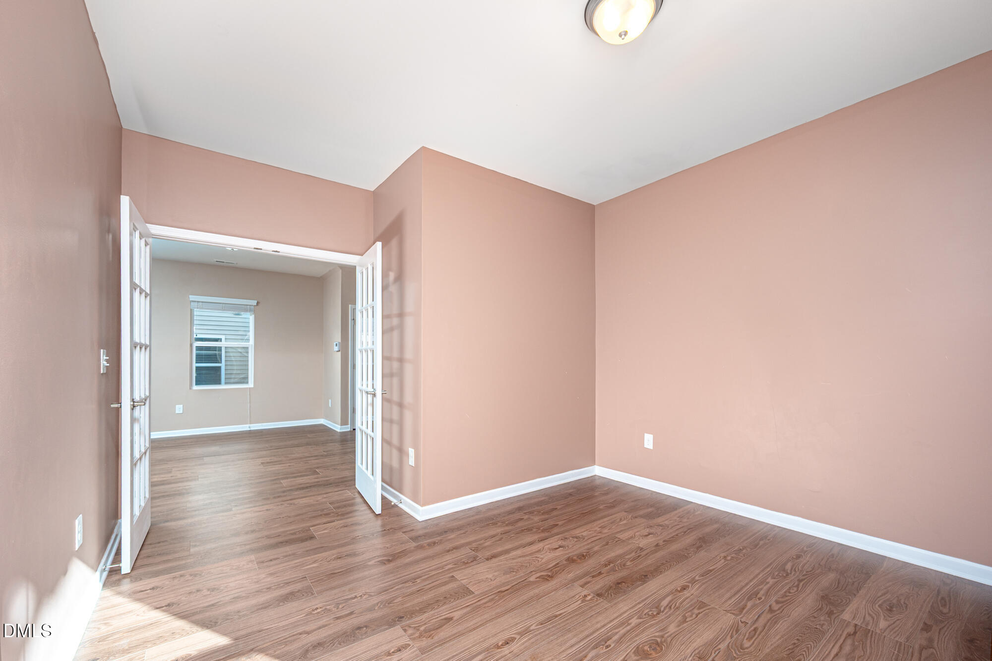 3548 Althorp Drive Raleigh, NC 27616 - Photo 9 of 56 a view of an empty room with wooden floor and a window
