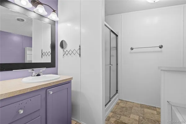 a bathroom with a double vanity sink a mirror and a shower