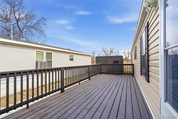 a view of deck with wooden floor and fence