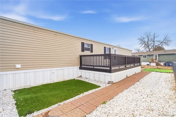 a view of house with backyard and a garden