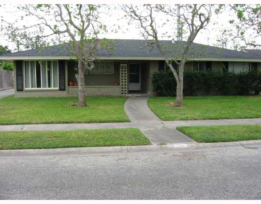 4334 Marie Street Corpus Christi, TX 78411 - Photo 1 of 4 a front view of a house with a yard and trees
