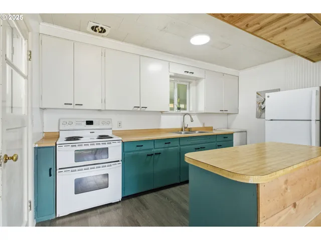 a kitchen with a stove a sink and a refrigerator