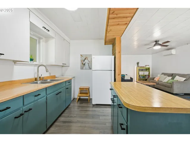 a kitchen with cabinets and wooden floor