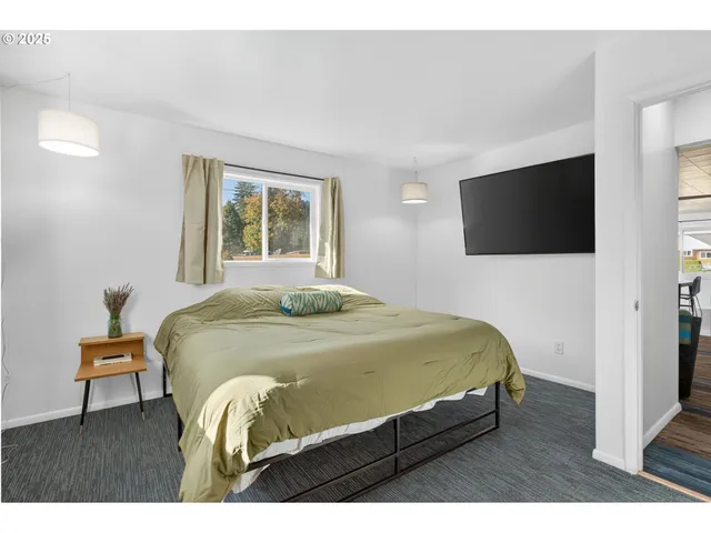 a bedroom with a bed and a flat screen tv