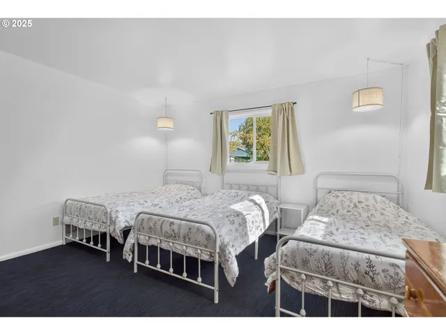 a bedroom with two beds and a window