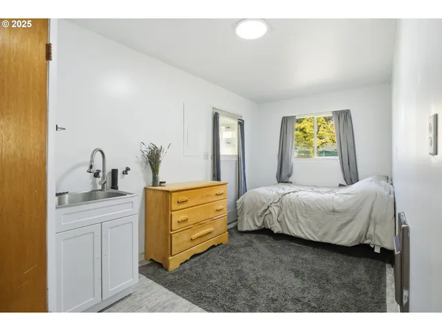 a bedroom with a bed and a dresser